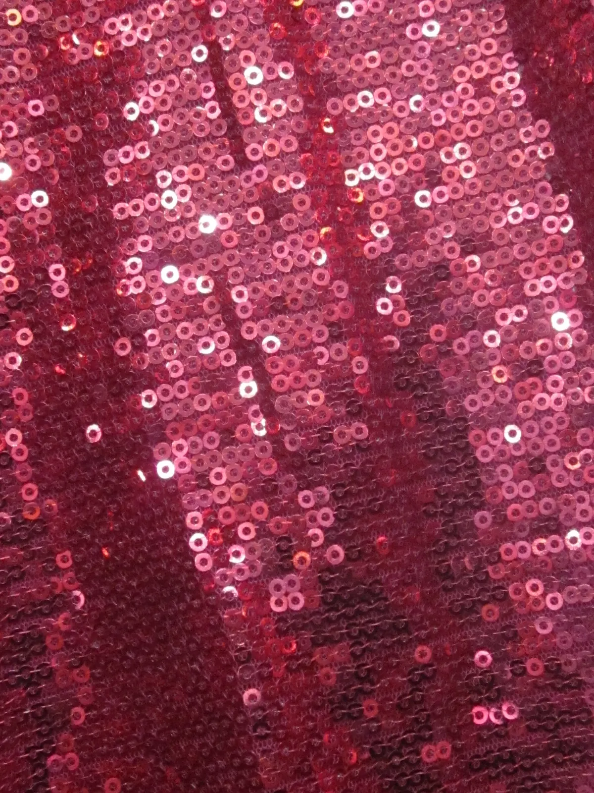 Close-up of pink sequin fabric catching the light
